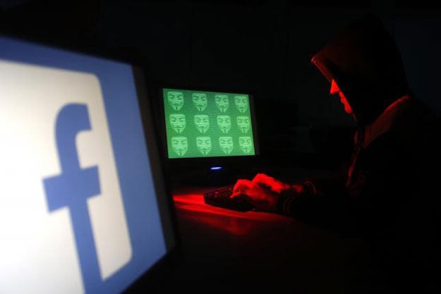 man poses in front of on a display showing a facebook logo and the word 039 cyber 039 in binary code in this picture illustration taken in zenica photo reuters