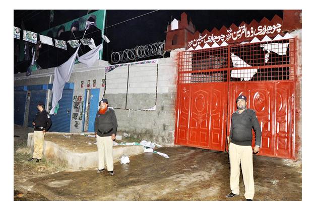 policemen standing alert at the site after angry people attacked the office of a political worker who allegedly killed the nephew of former provincial minister raja basharat in rawalpindi photo online