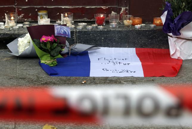 flowers and candles are seen placed outside the le carillon restaurant the morning after a series of deadly attacks in paris november 14 2015 photo reuters