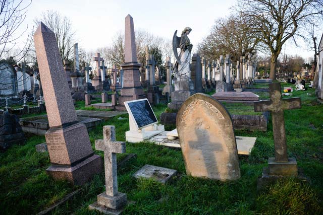 to go with afp story by edouard guihaire an unmarked grave with a headstone that resembles a computer screen nicknamed quot igrave quot by the cemetery club is seen in kensal green cemetery north west london on december 9 2015 some prefer to spend their leisure time immersed in music or on the sports field but for a small group of tombstone tourists britain 039 s graveyards are their playground the quot cemetery club quot shares its appreciation of quot these often overlooked and misunderstood places quot every monday on a blog which is followed by a band of quot taphophiles quot    the name given to cemetery enthusiasts photo afp
