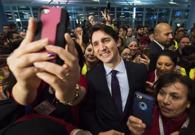 canadian prime minister justin trudeau poses for selfies with workers before he greets refugees from syria at pearson international airport in toronto on december 10 2015 photo courtesy the canadian press canadian prime minister justin trudeau poses for selfies with workers before he greets refugees from syria at pearson international airport in toronto on december 10 2015 photo courtesy the canadian press