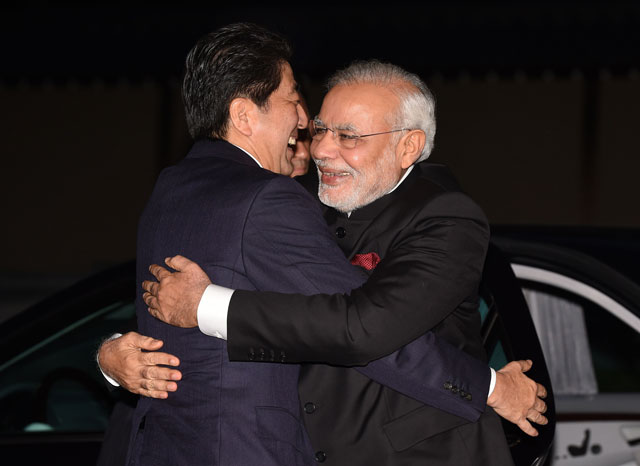 in this photograph taken on august 30 2014 india 039 s prime minister narendra modi r is embraced by his japanese counterpart shinzo abe upon his arrival at the state guest house in kyoto photo afp