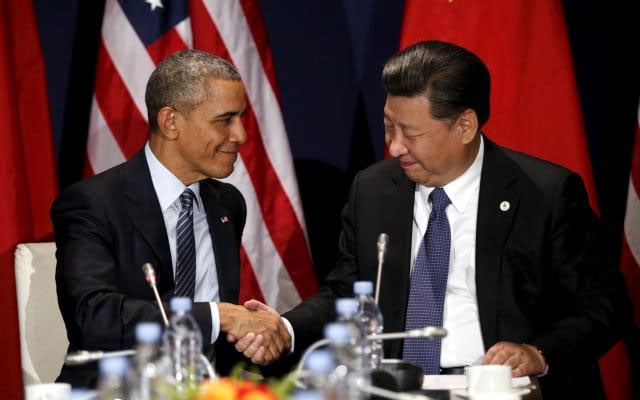 u s president barack obama shakes hands with chinese president xi jinping during their meeting at the start of the climate summit in paris