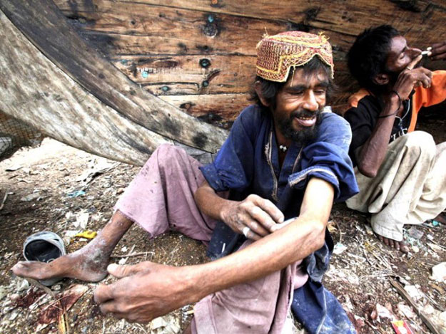 a drug addict injects heroin next to another addict at ibrahim hyderi fish harbour on the outskirts of karachi in this september 9 2011 file photo photo reuters