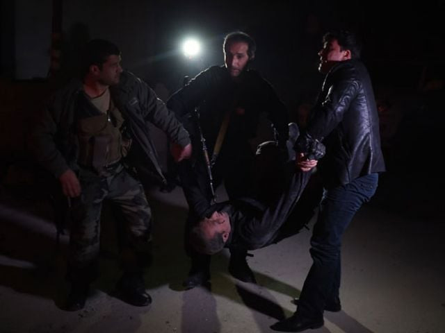 afghan security personnel carry a wounded man at the site of an attack near the spanish embassy compound in kabul on december 11 2015 photo afp afghan security personnel carry a wounded man at the site of an attack near the spanish embassy compound in kabul on december 11 2015 photo afp