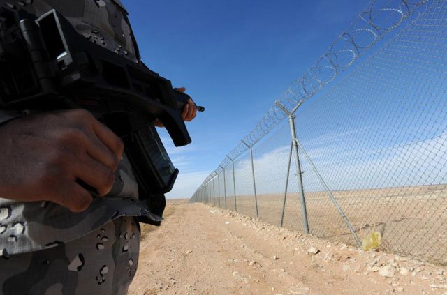 a member of the saudi border guards patrols the fence on saudi arabia 039 s northern border with iraq near arar city on february 23 2015 photo afp