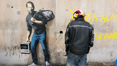 banksy s new work shows steve jobs as migrant banksy s new work shows steve jobs as migrant