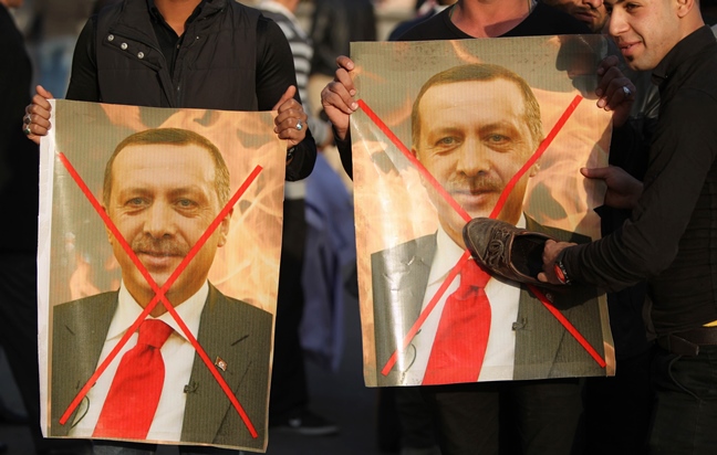 iraqis hold crossed out portraits of turkey 039 s president erdogan during a demonstration gathering mainly members of shia paramilitary forces in baghdad 039 s tahrir square on december 12 2015 photo afp