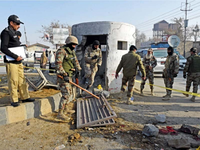 policemen and fc personnel comb the area for clues after the bomb explosion photo afp policemen and fc personnel comb the area for clues after the bomb explosion photo afp