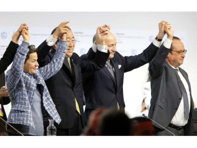 leaders raise hands after adoption of the global warming pact photo afp leaders raise hands after adoption of the global warming pact photo afp