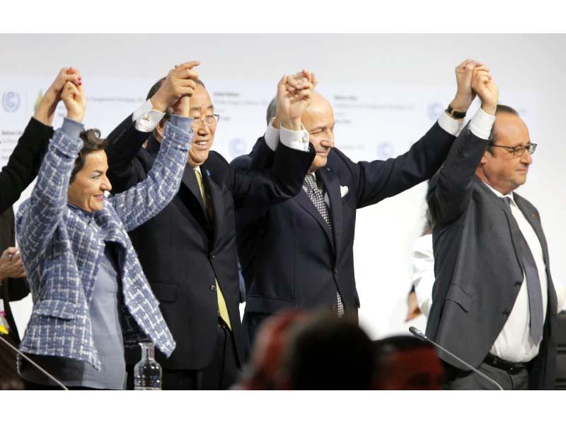 leaders raise hands after adoption of the global warming pact photo afp