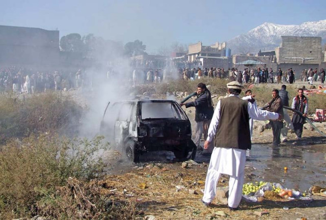 firefighters extinguish a fire in a vehicle at the bomb site in parachinar photo afp firefighters extinguish a fire in a vehicle at the bomb site in parachinar photo afp