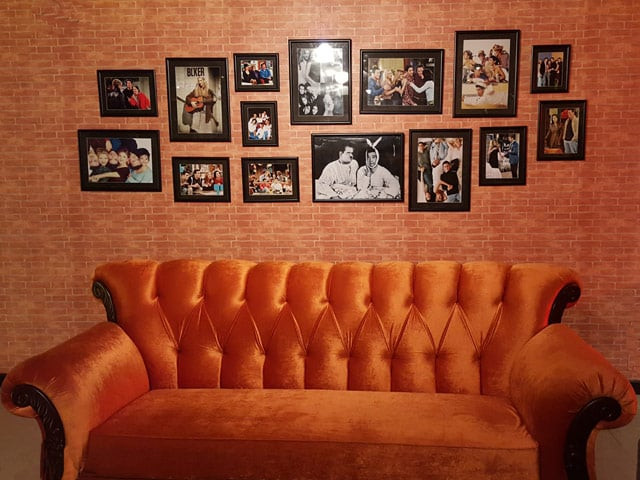the caf is fittingly filled with big orange couches with cast photos hung up on red brick walls photo ameena qayyum the caf is fittingly filled with big orange couches with cast photos hung up on red brick walls photo ameena qayyum