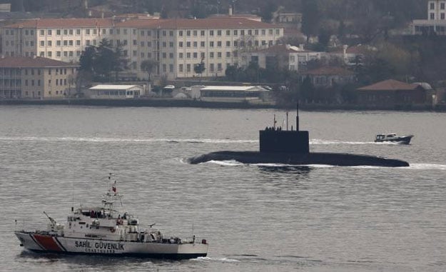 russia 039 s diesel electric submarine rostov on don is escorted by a turkish navy coast guard boat as it sets sail in the bosphorus on its way to the black sea in istanbul turkey december 13 2015 photo reuters