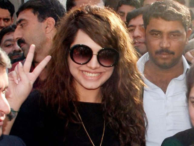 supermodel ayyan ali makes victory sign after getting her passports back from a customs court in rawalpindi on december 01 2015 photo nni