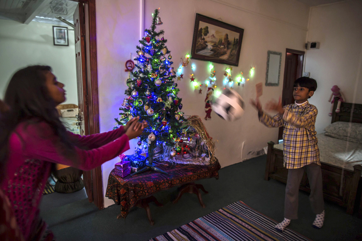 children play near a christmas tree ahead of christmas in islamabad december 24 2014 photo reuters