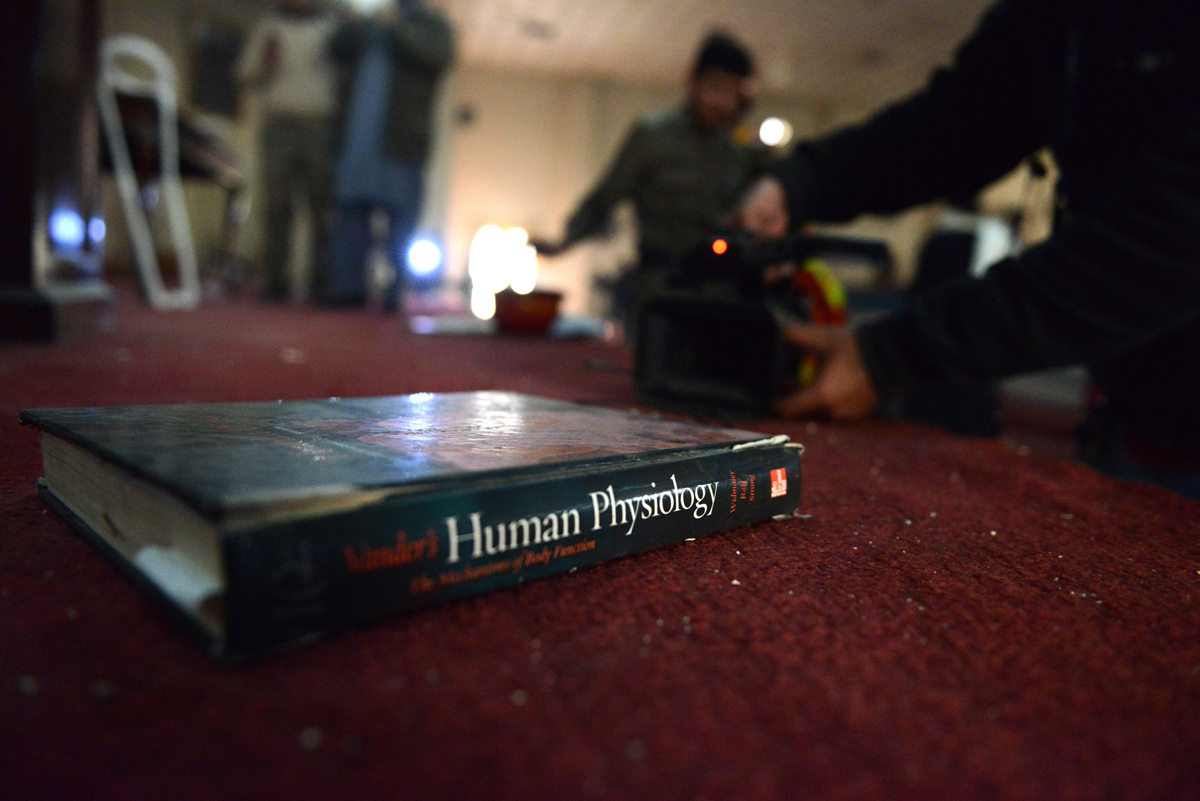 a school text book lies on the carpet at an army run school a day after an attack by taliban in peshawar on december 17 2014 photo afp