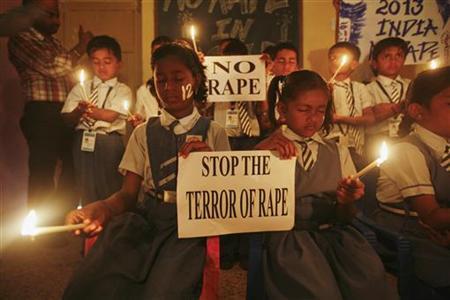 students hold candles as they pray during a candlelight vigil for a gang rape victim who was assaulted in new delhi in ahmedabad photo reuters