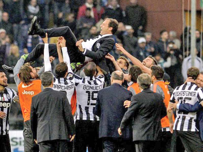 juventus players lift max allegri in the year after winning the serie a as the former milan coach found the right formula to take their domestic dominance into europe photo afp