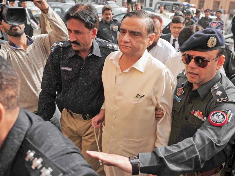 police escort dr asim to his hearing in the atc photo afp