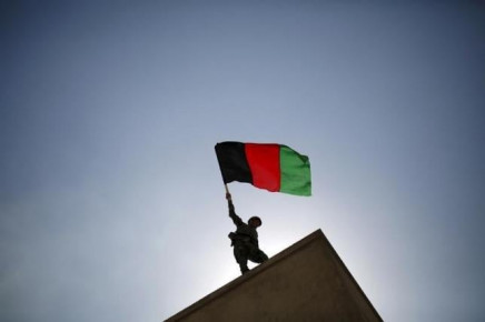 an afghan national army ana officer holds an afghanistan flag during a training exercise at the kabul military training centre in afghanistan october 7 2015 photo reuters