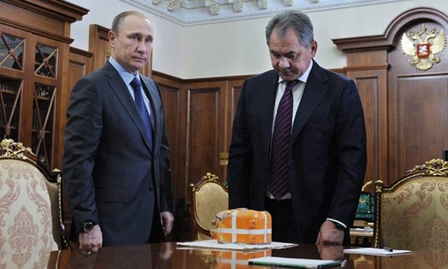 vladimir putin and sergei shoigu with what is said to be the flight recorder from the russian su 24 bomber shot down by turkey photo mikhail klimentiev sputnik kremlin pool epa