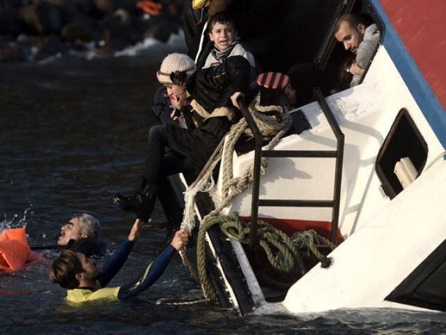 a young boy cries out for help with other refugees and migrants as their boat sinks off the greek island of lesbos island while crossing the aegean sea from turkey on october 30 2015 photo afp a young boy cries out for help with other refugees and migrants as their boat sinks off the greek island of lesbos island while crossing the aegean sea from turkey on october 30 2015 photo afp