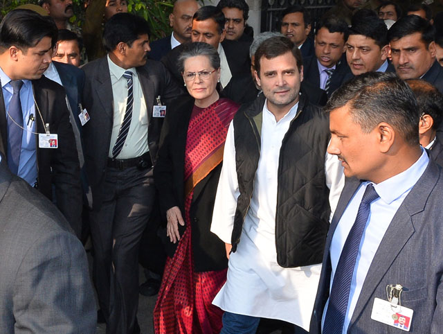 vice president of india 039 s congress party rahul gandhi 2r walks with his mother and party president sonia gandhi c and officials as they leave patiala house court in new delhi on december 19 2015 after a court appearance by the pair photo afp