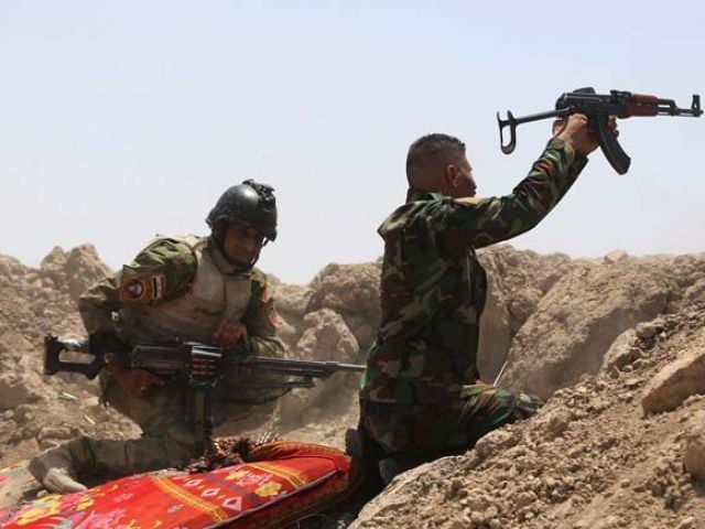 iraqi soldiers fire towards islamic state is group positions in the garma district of anbar province west of the iraqi capital baghdad on may 19 2015 photo afp