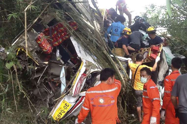 thai rescue workers evacuting injured passengers from the wreckage of a tourist bus after it crashed on a mountain roadside in doi saket district chiang mai province on dec 20 2015 photo epa