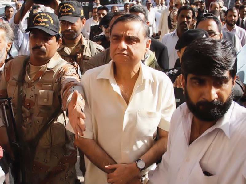 rangers personnel escort former federal minister dr asim hussain to his hearing in the court photo file