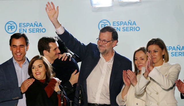 spanish prime minister popular party pp leader and candidate for general election mariano rajoy 3rd r waves after delivering a speech next to his wife elvira fernandez r vice president of the spanish government soraya saenz de santamaria l pp secretary general and candidate maria dolores de cospedal r and other party members at pp 039 s headquarters after the results of spain 039 s general election in madrid on december 20 2015 photo afp