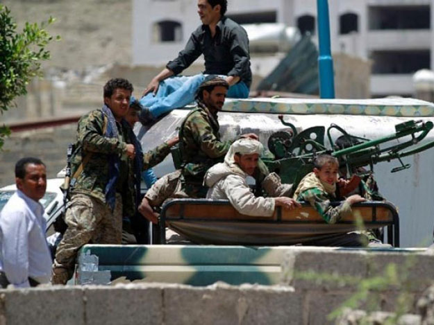 armed fighters of the shia huthi movement sit in a pick up truck mounted with a machine gun in southern sanaa on april 21 2015 close to a missile depot on fajj attan hill that was hit by saudi led coalition air strikes photo afp