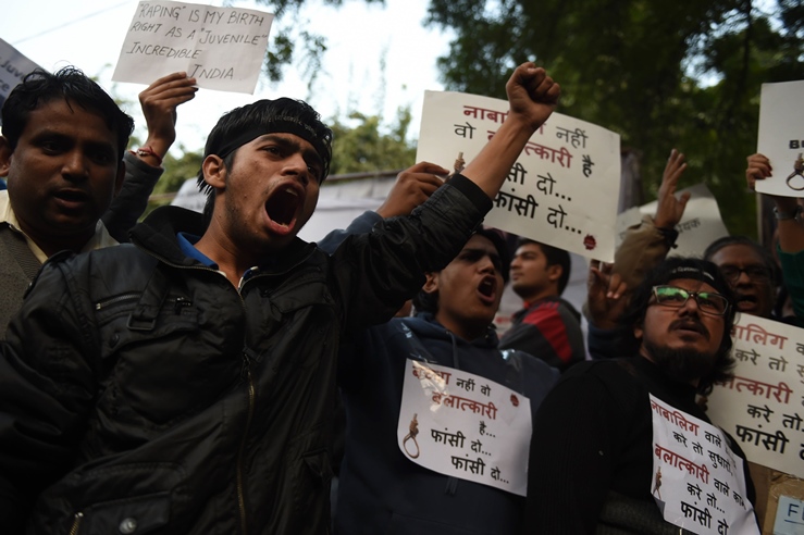 indian protesters hold placards and shout slogans during a demonstration against the release of a juvenile rapist in new delhi on december 21 2015 photo afp