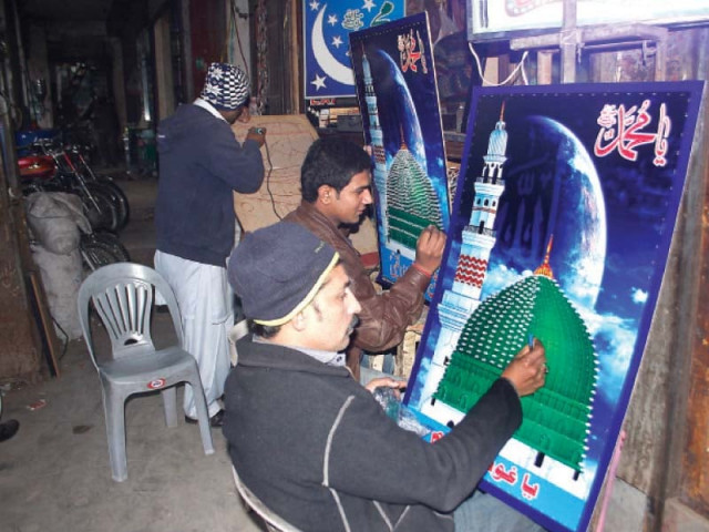 vendors put up light bulbs on posters carrying a photo of masjidul nabwi photo shafiq malik amp abid nawaz