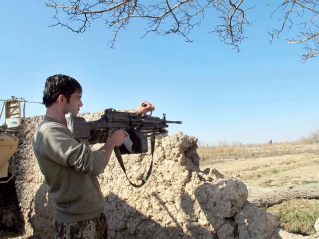 an afghan national army soldier keeps watch during an ongoing battle with taliban militants in the nad ali district of helmand on tuesday photo afp an afghan national army soldier keeps watch during an ongoing battle with taliban militants in the nad ali district of helmand on tuesday photo afp