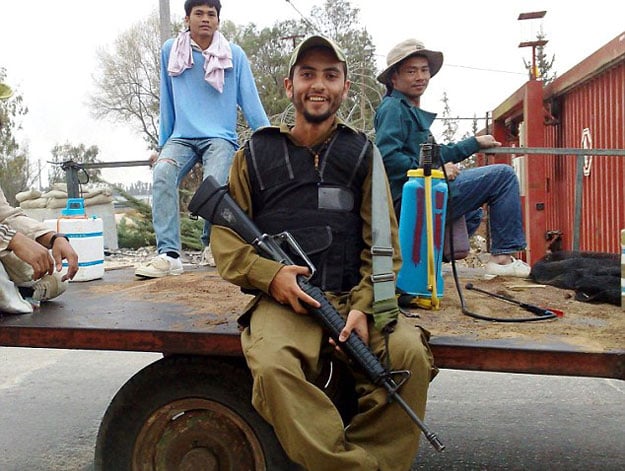 mohammad ka 039 abiya centre poses with his weapon while serving in the israel defence force idf photo mohammad ka 039 abiya