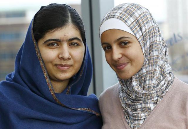 malala yousefzai l poses with 17 year old syrian refugee muzoon almellehan at the city library in newcastle upon tyne britain december 22 2015 photo reuters