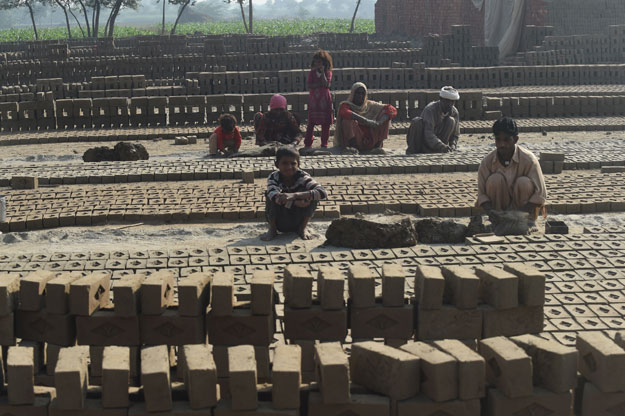 in this photograph taken on november 19 2015 pakistani labourers work at a brick factory where a christian couple were lynched and burnt alive in the town of kot radha kishan photo afp