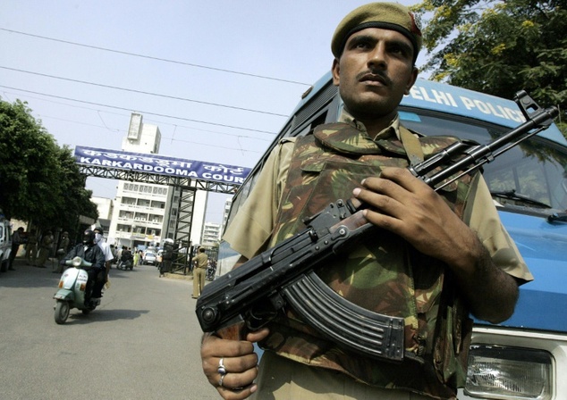 a policeman stands guard outside the karkardooma courthouse in new delhi photo afp