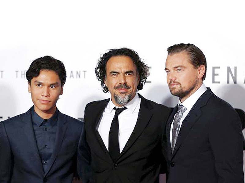 director alejandro gonzalez inarritu c poses with cast members leonardo dicaprio r and forrest goodluck l at the premiere of the revenant in hollywood photo reuters