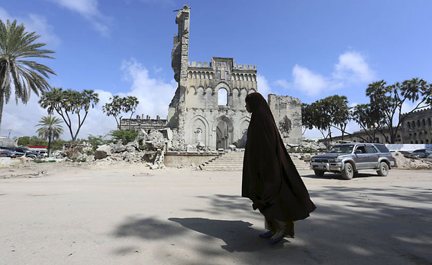 a woman walks past a section of mogadishu cathedral that was built by italian authorities in mogadishu somalia photo reuters