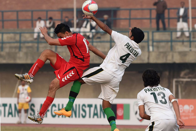 two pakistani defenders challenged an afghan player during an exhibition in february photo afp