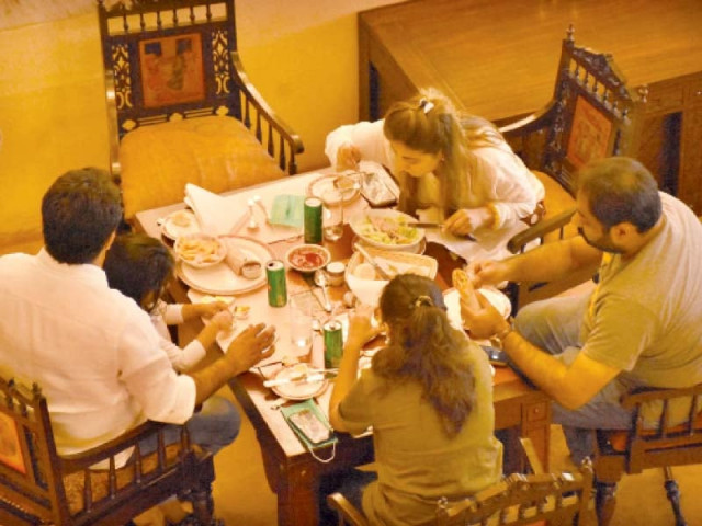 a family enjoys a meal at a restaurant in the federal capital on monday after the govt allowed dine in services photo online a family enjoys a meal at a restaurant in the federal capital on monday after the govt allowed dine in services photo online