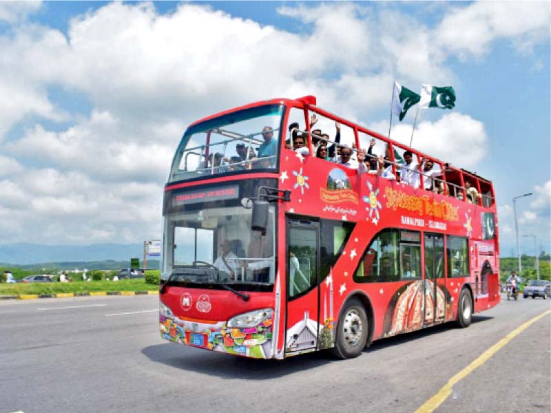 students and government officials enjoying a ride on the double decker bus wave during the test run of the service on friday photo express