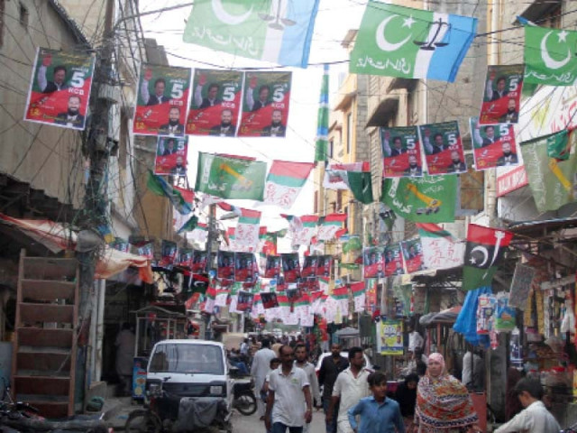 a lane in a cantonment area of karachi adorned with flags of various political parties photo online a lane in a cantonment area of karachi adorned with flags of various political parties photo online