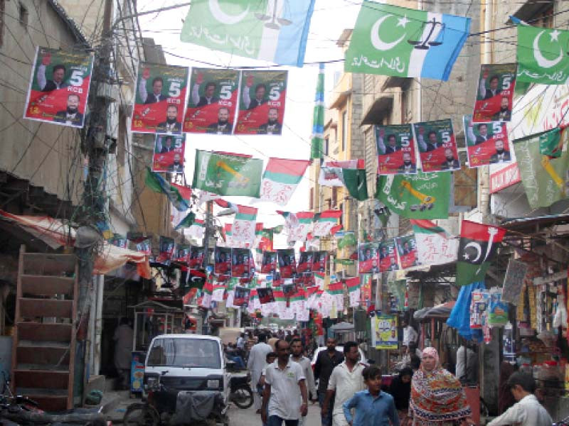 a lane in a cantonment area of karachi is adorned with flags of various political parties photo online