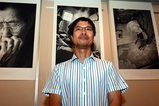 ahn sehong stands before his photographs of korean quot comfort women quot prior to a press conference in tokyo photo afp