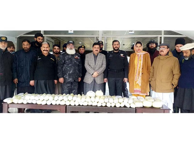 customs official pictured with the heroin recovered from a vehicle near the torkham border photo express abuzar afridi