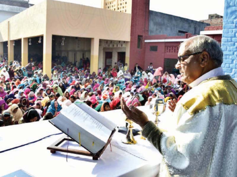 a pastor gives a sermon on christmas at st joseph catholic church in sargodha photo app